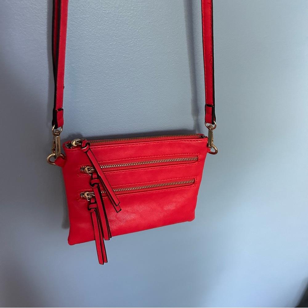 Pink leather purse with cross body strap